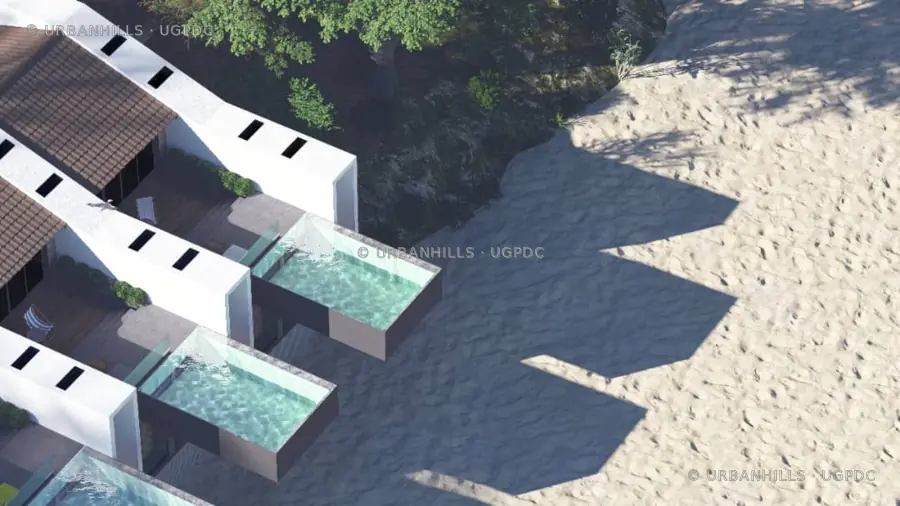 Close aerial detail of private villa pools beside a sandy beach